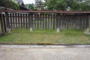 A wooden fence with a wooden gate in front of it photo