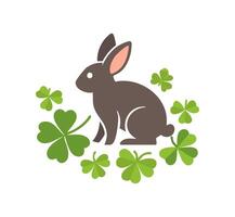 rabbit nibbling on clover leaves vector