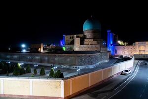 Samarkand, Uzbekistan-august 12, 2023-view of the Registan square occupied by a large complex made up of 3 madrasas famous for the purity of the lines and the elegance of the majolica by night photo