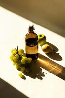 a bottle of oil grapes and apples on a table photo