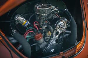 Open bonnet of a classic car displaying fully restored engine compartment. photo