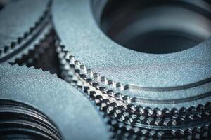 Close up of small metal gears and parts stacked up after production photo
