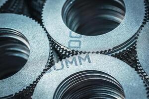 Close up of small metal gears and parts stacked up after production photo