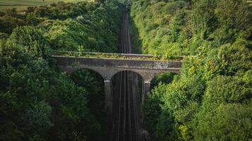Rail track tunnel, in a green hill, Brighton, East Sussex, UK photo
