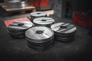 Close up of small metal disks stacked up after production photo