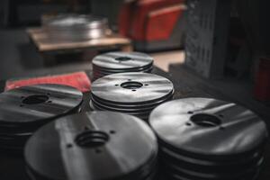 Close up of small metal disks stacked up after production photo