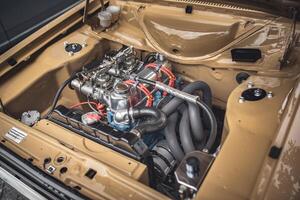 Open bonnet of a classic car displaying fully restored engine compartment. photo