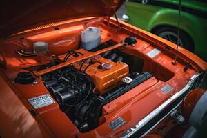 Open bonnet of a classic car displaying fully restored engine compartment. photo