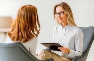 Female psychologist and client doing therapy in a psychologist interview. Job interview between a human resources employee and a candidate. photo