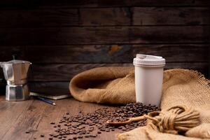 The picture of coffee beans stacked together on a wooden floor in a warm, light atmosphere, on a dark background, with copy space. photo