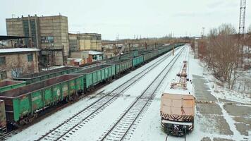 Four rows of containers are located at the railway station near the state building outside the city. Aerial view. video