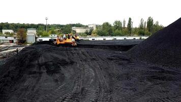 Open pit mine, breed sorting. Mining coal. Bulldozer sorts coal. Extractive industry, anthracite. Coal industry. video