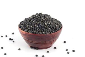 Urad dal, black gram, Vigna mungo in wooden bowl on white background photo