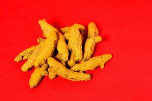 Barks of Yellow Turmeric on Red Background photo