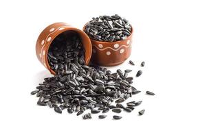 Sunflower seeds in a pot on a white background photo