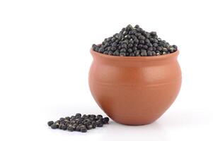 Black mustard seeds in a clay pot photo