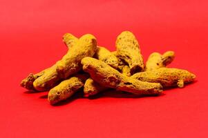 Barks of Yellow Turmeric on Red Background photo