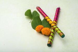 Two colorful sticks with leaves and flowers photo