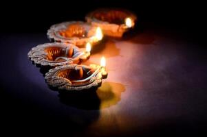 Three small candles are lit in a row photo