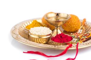 A gold plate with various colored powders and a red string photo