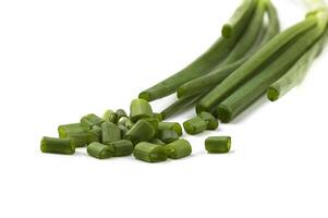 Fresh ripe green spring onions shallots or scallions with fresh chopped green onions on white background photo