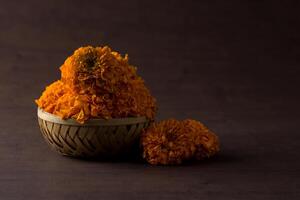 A basket filled with orange flowers on a table photo