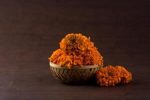 A basket with orange flowers sitting on a table photo