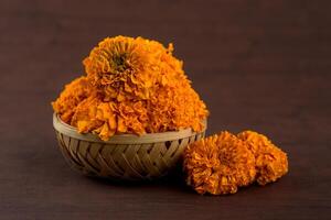 A basket filled with orange flowers on a table photo