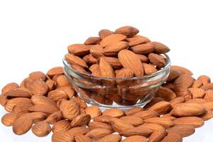 Almonds in a glass bowl on a white background photo
