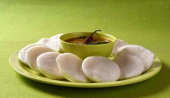 A plate with some white bread and a bowl of sauce photo