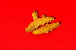 Barks of Yellow Turmeric on Red Background photo