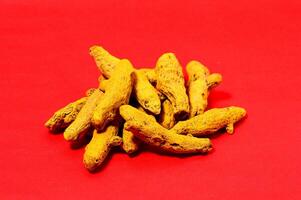 Barks of Yellow Turmeric on Red Background photo