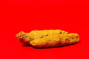 Two pieces of yellow food on a red background photo
