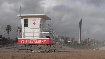A lifeguard tower on the beach with a stormy sky video