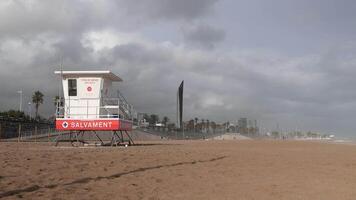 A lifeguard tower on a beach with a cloudy sky video