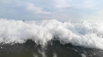 A large wave crashing into the ocean video