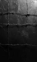 Shadows of barbed wire casting on a wall, empty space for dramatic effect, monochrome theme photo
