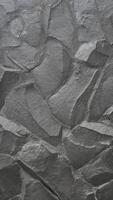 Grey rock stone texture portrait background wall pattern, top view. Background design for dark wallpaper. photo