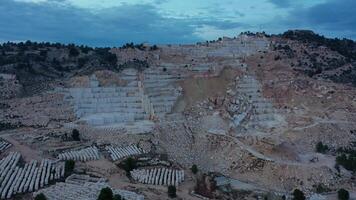 Aerial view of Open-air mining activity in a white marble mine. video