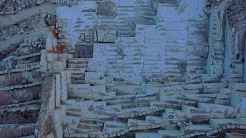 Aerial view of Open-air mining activity in a white marble mine. video