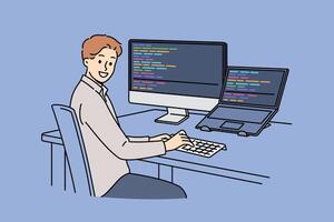 Man programmer types code and looks at camera, sitting at table with computer and laptop vector