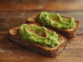 Creamy mashed avocado spread on whole grain toast, garnished with spices, creates rustic and healthy snack. Perfect for breakfast or light meal photo