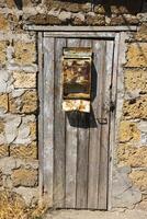 Old front door with mailbox and peeling paint. photo