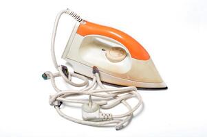 Electric iron with tangled cord white background photo