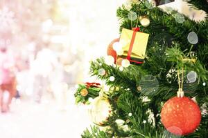Christmas tree background. Close up of balls on christmas tree. Bokeh garlands in the background. photo
