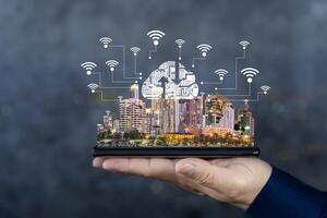 Smart City and Internet of Things IOT on smartphone in hand, object icons connected together, internet network concept. photo