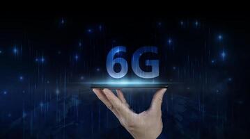 Businessman holding a smartphone with hologram 6G digital technology, access to information around the world. 5G wireless internet network concept or IOT photo