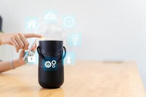 Man turns on smart speaker with active artificial intelligence assistant with futuristic screenless interface with different icons and symbols. photo