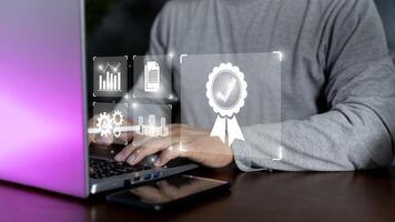 Businessman hands are using laptop at document and correct mark for standard quality control certification concept. photo