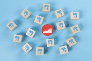 Franchise expansion wooden blocks display store icons for e commerce and digital marketing branches. photo